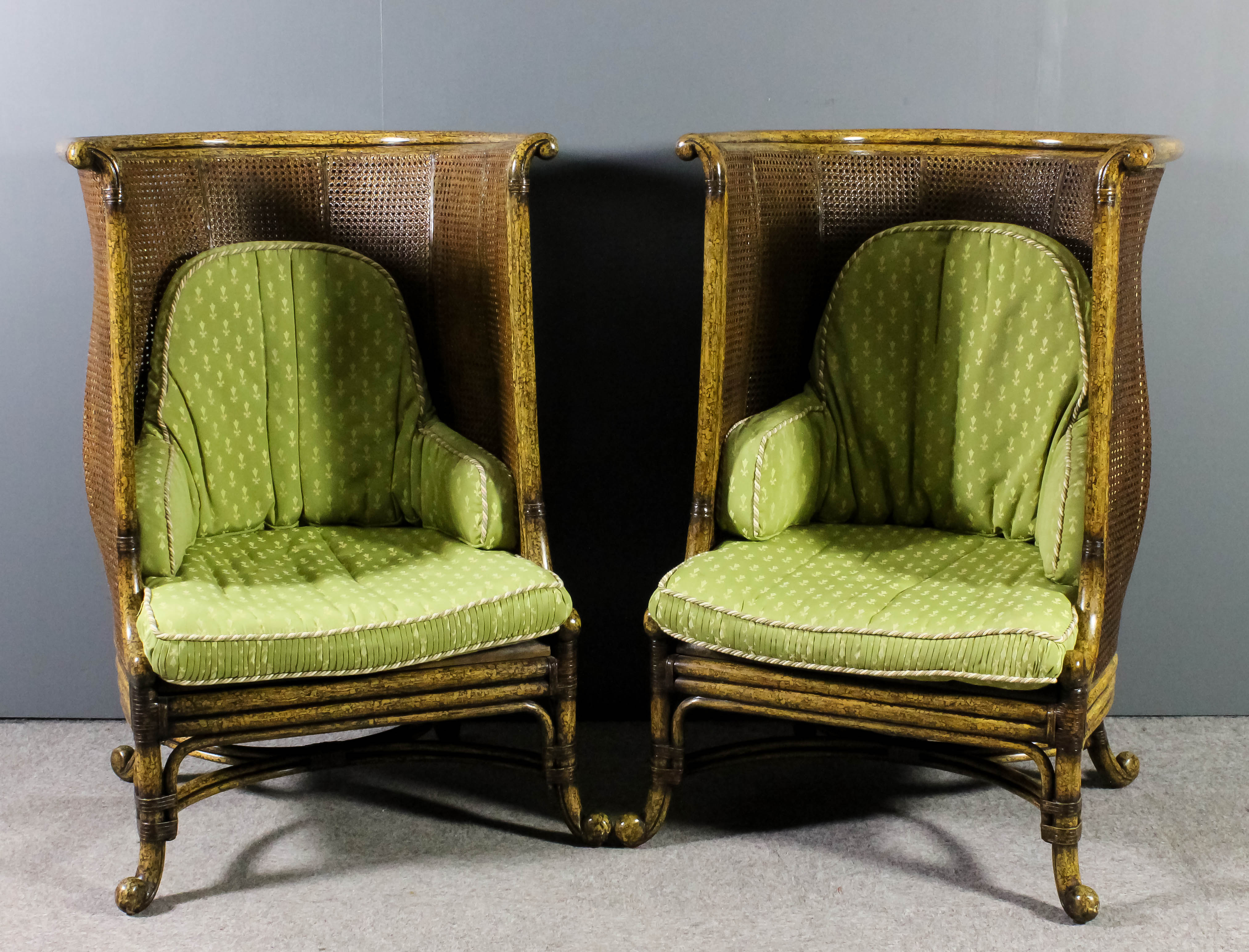 A pair of modern simulated bamboo framed high back tub shaped easy chairs with double cane backs,