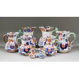 A collection of twenty Masons ironstone jugs painted with an "Imari" pattern, from 2.75ins high to