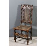 A Carolean walnut high back chair, the crest rail fretted and carved with a crown, a cherub and leaf