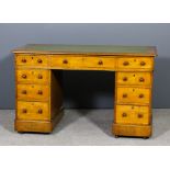 A Victorian oak kneehole desk with green leather inset to top and moulded edge, fitted nine drawers,