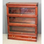 An early 20th Century Globe Wernicke mahogany three tier sectional bookcase, each tier enclosed by