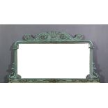 A green painted overmantel mirror, the shaped cresting moulded with "Prince of Wales Feathers" and