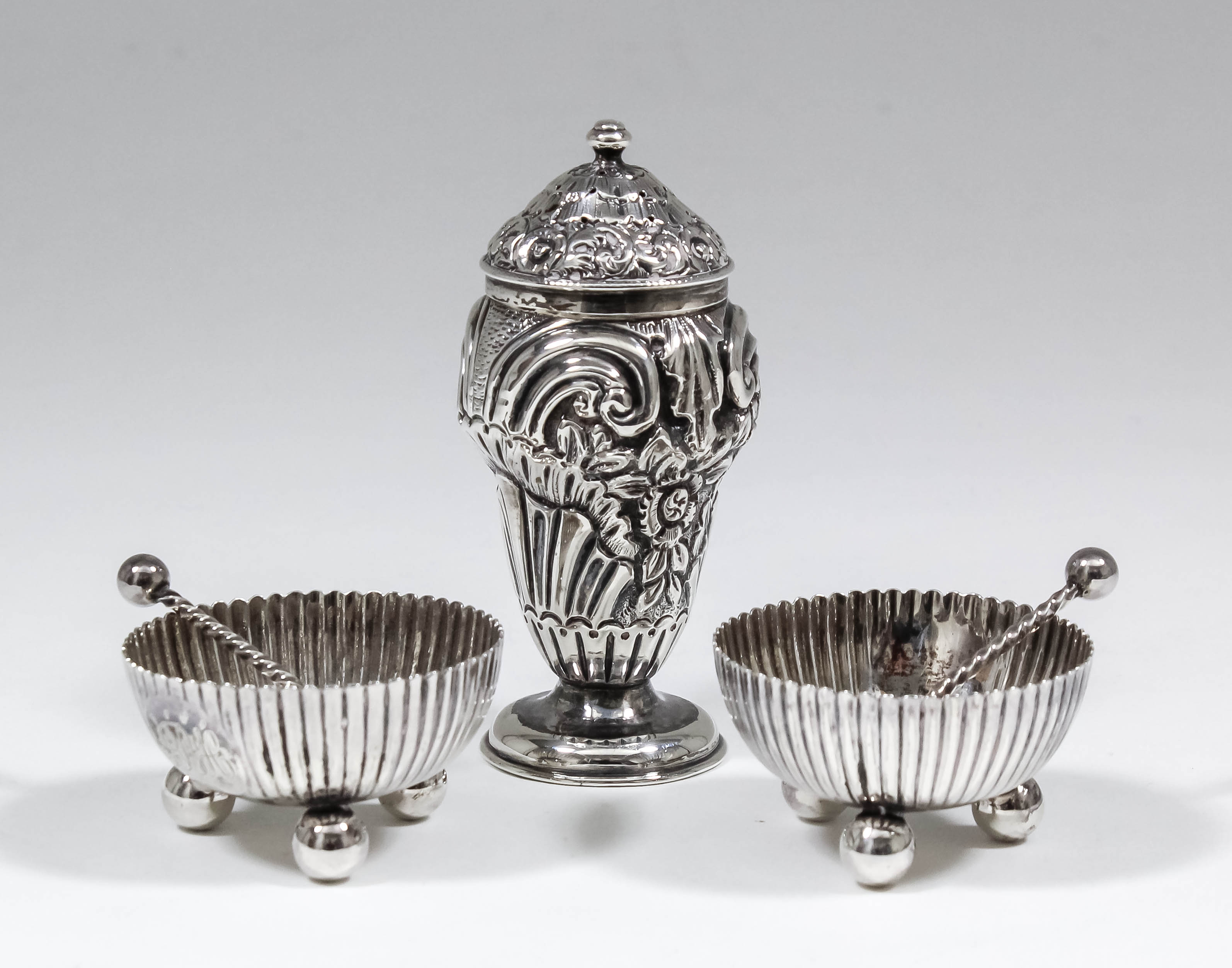 A pair of Victorian silver circular salts with reeded bodies and each on three ball feet, 1.875ins