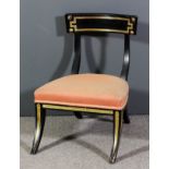A 19th Century ebonised and parcel gilt "Klismos" nursing chair with deep curved crest rail, the