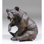 A late 19th Century "Black Forest" carved wood seated bear, 6ins high