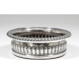 A George IV silver circular coaster with gadroon mounts to rim and part reeded body, on turned