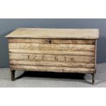 An early 18th Century stripped pine plank coffer, the two plank top with moulded edge and with