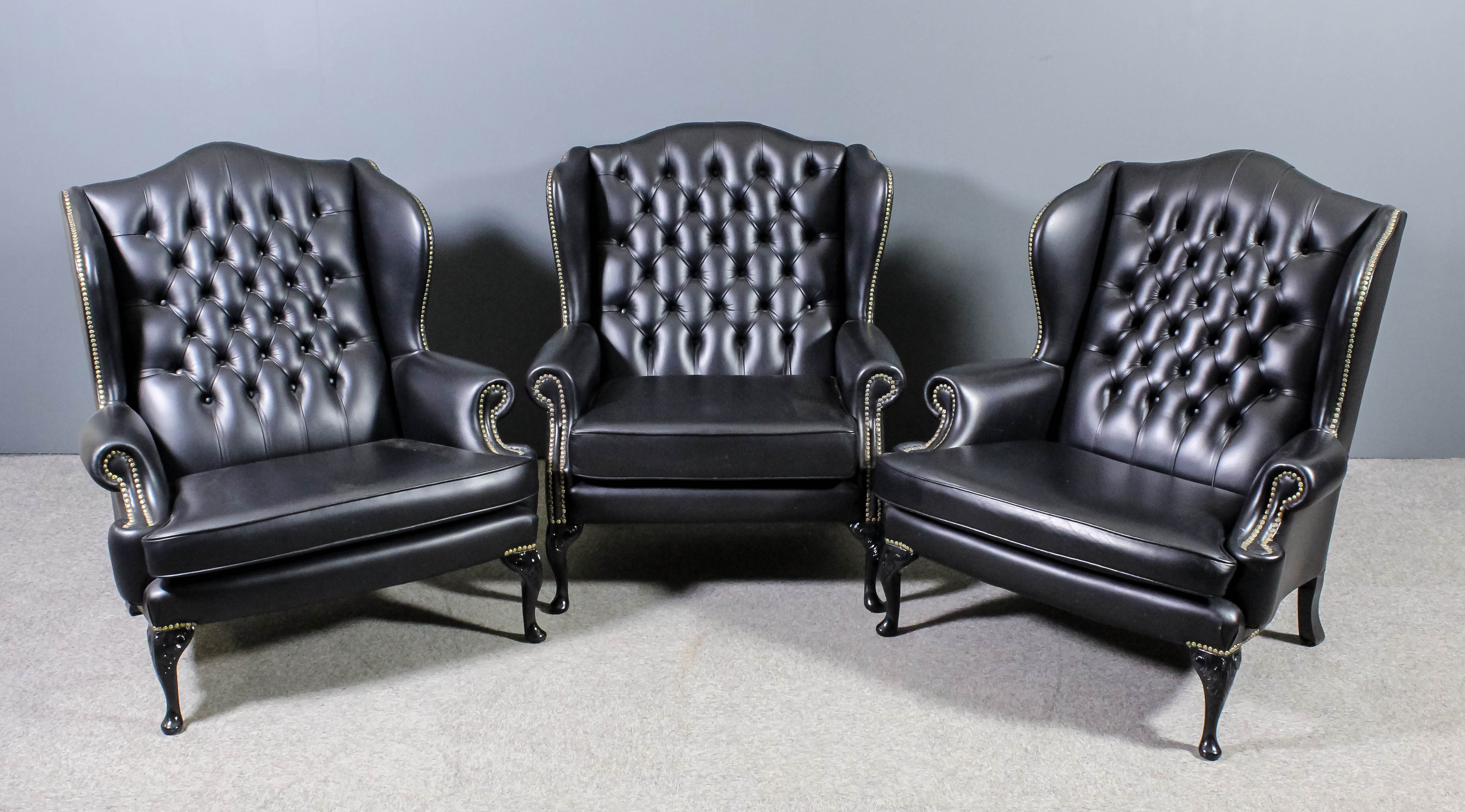 A pair of modern wing back easy chairs of large proportions and of "18th Century" design, with