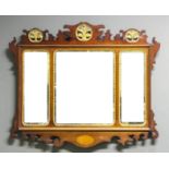 A mahogany and parcel gilt rectangular wall mirror of 18th Century design, the shaped and carved