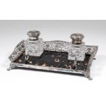 A late Victorian silver and tortoise-shell rectangular inkstand, the shaped rim pierced and cast