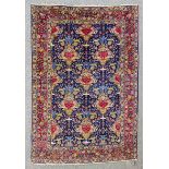 A Tabriz rug woven in colours with three rows and two half rows of stylised urns of flowers, the