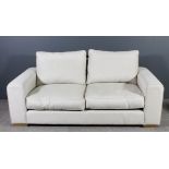 A modern two seat settee of large proportions, upholstered in cream cloth, 78ins wide x 40ins deep x