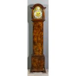 An early 20th Century walnut cased "Grandmother" clock, the 8.5ins arched brass dial with silvered