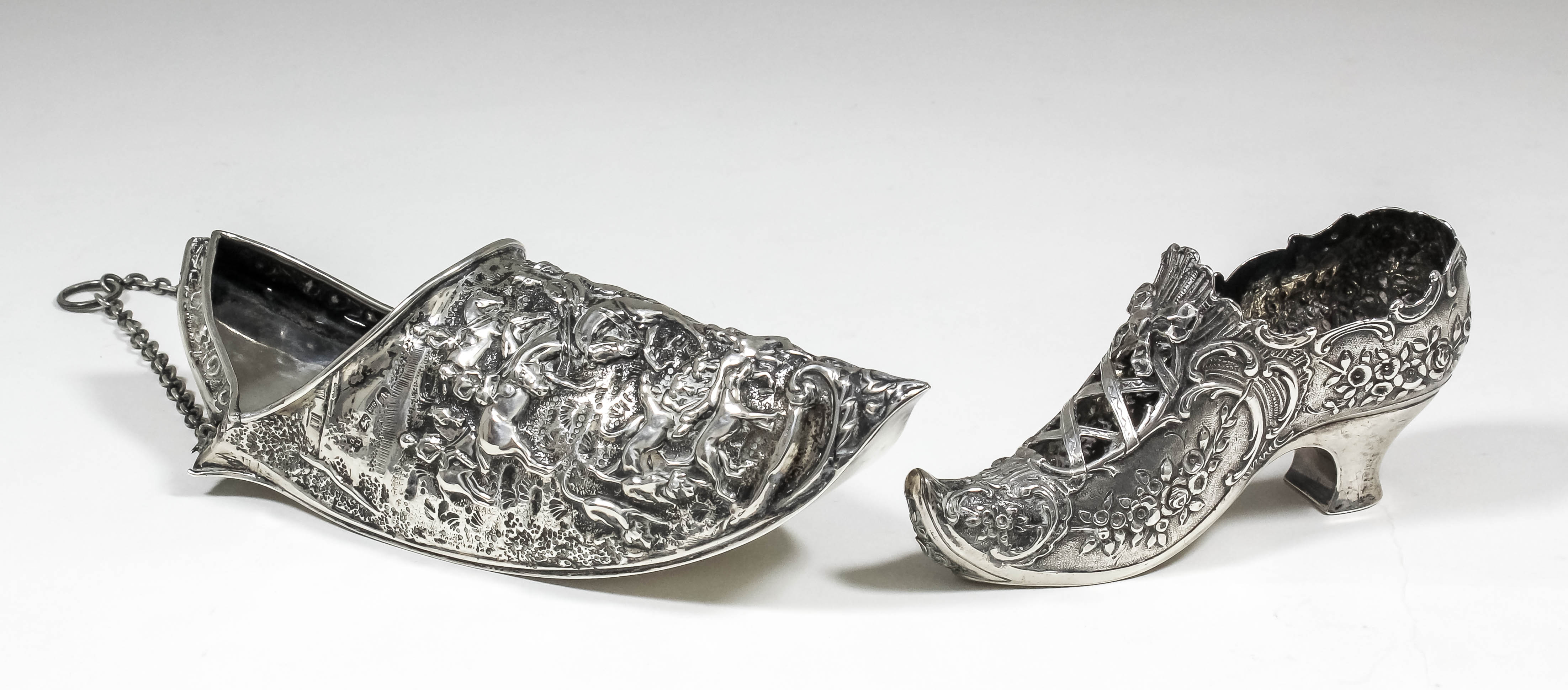 An Edward VII silver wall pocket in the form of a pointed shoe, cast with figures on horseback and