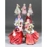 Nine Royal Doulton bone china figures, comprising - "Autumn Breezes" (HN934) 7.5ins high, "The