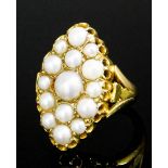 An early 20th Century 18ct gold and seed pearl dress ring of Victorian design, the ovoid face set