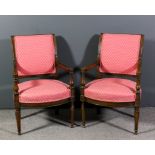 A pair of French walnut framed scroll back fauteuil with moulded showwood frame, the seat and back