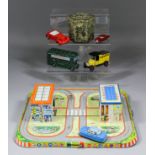 A German tinplate clockwork roadway with two buildings, single car and moving family, 12ins x 13.