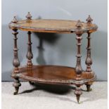 A Victorian figure walnut oval two tier occasional table, the top inlaid with floral arabesques,