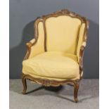 A French walnut framed fauteuil of Louis XV design, the moulded showwood frame with scroll and