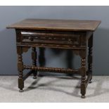 A 17th Century oak lowboy with cleated two plank top, fitted one frieze drawer, the front and