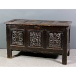 A 17th Century panelled oak coffer with four panels to lid and three panels to front carved with