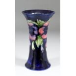 A Moorcroft pottery vase of waisted form tube lined and decorated in colours with "Pansy" design, on