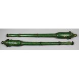 A pair of turned wood and green painted tipstaffs, each 23.5ins