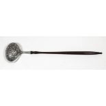 A late 18th Century silvery metal oval punch ladle embossed with bands of floral and leaf ornament