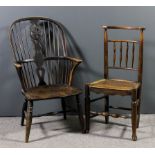 A 19th Century ash and elm seated wheel and stick back Windsor armchair with two tier back, on