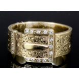 A modern gentleman's 9ct gold diamond set buckle pattern ring, the face with foliate engraving,