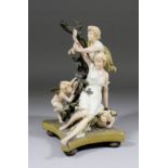 An Austrian Ernst Wahliss pottery figure of two young lovers and two winged cupids, 11ins high (