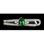 A platinum jade and diamond set tie pin, the face set with an oval cabochon, 9mm x 6.5mm, bordered