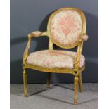 A French gilt framed fauteuil of Louis XVI design with moulded showwood frame, the oval back, seat