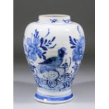 A late 18th/early 19th Century Dutch Delft blue and white baluster shaped vase painted with a bird