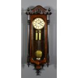 A late 19th Century walnut and ebonised "Vienna Regulator" wall clock, the 7ins diameter cream