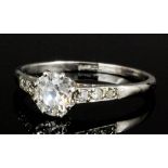 A silvery coloured metal mounted diamond solitaire ring, the old cut stone approximately .60ct (