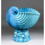 A Burmantofts turquoise glazed pottery jardiniere modelled as a nautilus shell supported on a