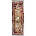 A Sarape runner woven in colours with a central pole medallion with three lozenge shaped panels,