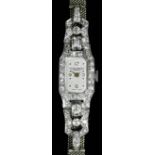 A 1930s lady's 18ct white gold diamond set Baume & Mercier cocktail watch, the silvered dial with