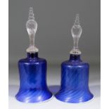 Two similar 19th Century blue glass bells with wrythen decoration, 12ins and 13ins high (lacking