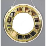 A heavy brass circular clock chapter ring, with Roman numerals, 18ins diameter, mounted on