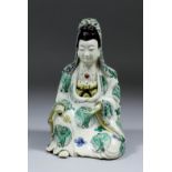 A Chinese porcelain figure the Bodhisattva Guanyan seated with one knee raised in the "Royal