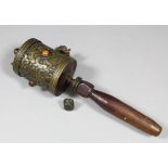 A Tibetan brass cylindrical prayer reel cast with scroll ornament and applied with coloured