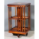 A mahogany square revolving two tier bookcase in the Edwardian manner, the top with reeded edge