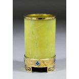 A Chinese yellow jade cylindrical brush pot with silver gilt and enamel mounts and rim, the plain