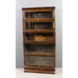 A Globe Wernicke oak five tier sectional bookcase, each tier enclosed by a rising glazed panel, on