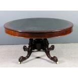 A Victorian mahogany circular library table, the top with blue leather inset and moulded edge and