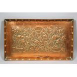 An early 20th Century copper rectangular tray of Arts & Crafts design, embossed with birds in