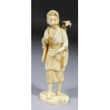 A 19th Century Japanese carved ivory standing figure of a woman carrying a basket of flowers on